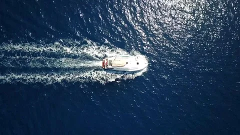 Aerial top down view of motor boat sailing on open sea like a bullet. Stock Footage 252730127