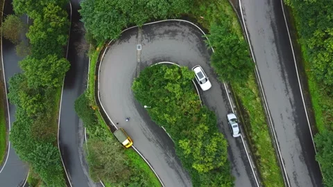 Aerial top down view on the mountain hairpin road in forest near the golden wate Stock Footage 146075935