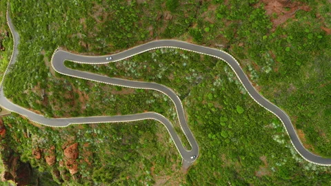 Aerial top down view of mountain serpentine windy road with moving cars. Road Stock Footage 220809137
