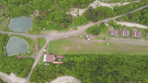 Aerial top-down view of mountain tourist resort in Digora Gorge Stock Footage 337462731