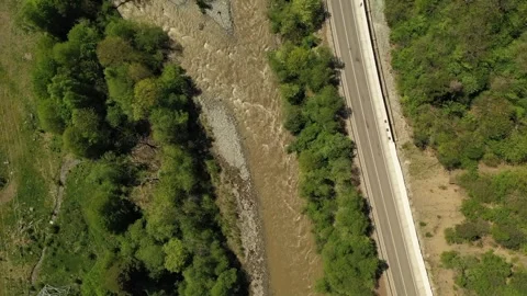 Aerial top-down view of a mountain river and road in spring Stock Footage 338005707