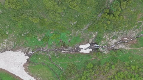 Aerial Top Down View of Mountain Stream and Snow Stock Footage 345388212