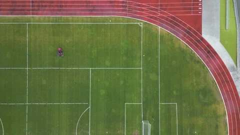 Aerial Top Down View of Mower Cutting Grass on Soccer Field 库存影片 331304715