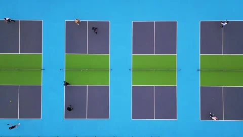 Aerial top-down view of multiple pickleball courts with players engaged in a Stock Footage 300953589