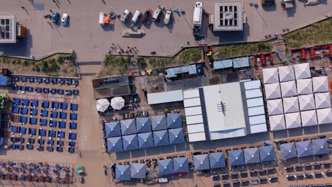 Aerial top down view of multiple luxury beach clubs with large geometric Stock Footage 338416896