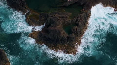 Aerial top-down view of natural pools and ocean waves at Seixal, Madeira Island 動画素材 299960734