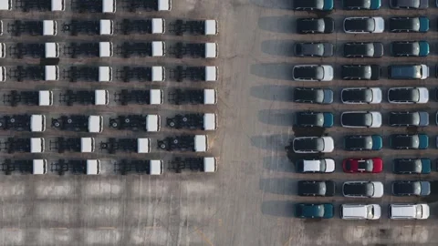 Aerial top down view of new cars and truck chassis in a parking lot Stock-Footage 331661016