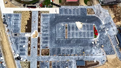 Aerial top down view of a newly built cobblestone parking lot and town square Stock Footage 348805555
