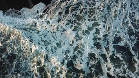 Aerial top down view of ocean tide wave on black sand, moving up Stock Footage 98156540