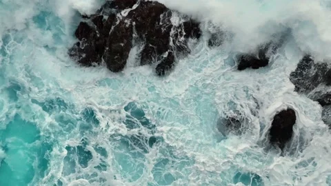 Aerial top down view of ocean surf crashes on the rocks. Stormy powerful waves Stock Footage 169694221