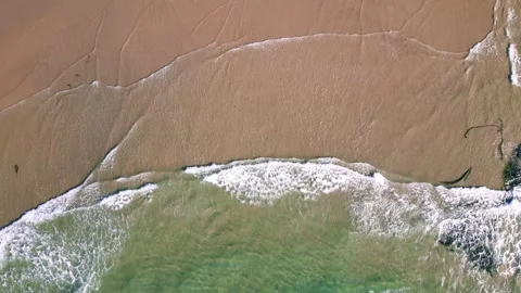 Aerial top down view of Ocean waves hitting sandy beach at Pacific coast of.. Stock Footage 310353406