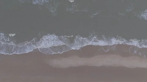 Aerial Top Down View of Ocean Waves Washing Onto Sandy Beach Stock Footage 322992660