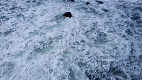 Aerial top down view of ocean waves crashing on dark rocks The Concept of N.. Stock Footage 327404789