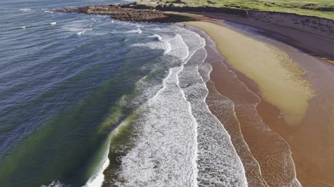 Aerial Top Down View of Ocean Waves Meeting Sandy Beach Video stock 333784458