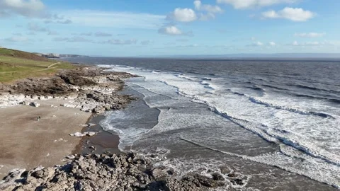 Aerial Top Down View of Ocean Waves and Rocky Shore, UK 4K Stock-Footage 334067203