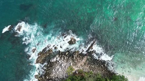 Aerial Top Down View of Ocean Waves Crashing on Rocky Coastline in Phuket, Stock Footage 335583509