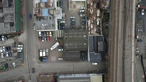 Aerial top down view of an old industrial area with vehicles and railway Vídeo Stock 173411071