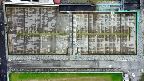 Aerial top down view of a old worn parking lot without cars Video stock 234968359