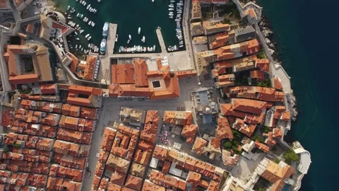 Aerial top down view of old town of Dubrovnik with boats and yachts in port on Stock Footage 260828971