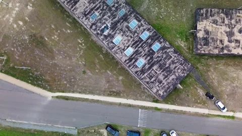 Aerial top-down view of old rectangular buildings near a waterfront. Paths Stock Footage 316374970