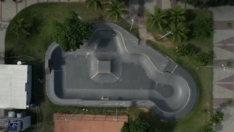 Aerial top down view of one person skateboarding at a skateboard park Stock Footage 232311432