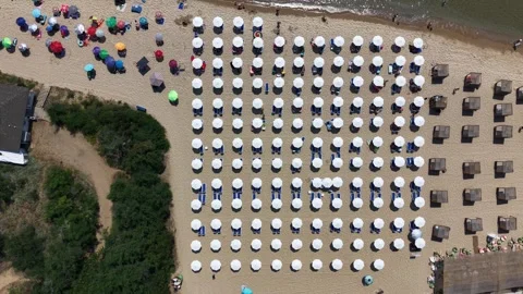 Aerial top down view of organized beach with white umbrellas and sunbeds Stock Footage 338200897