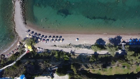 Aerial top down view of an organized sandy beach next to lush trees. Stock Footage 343940268