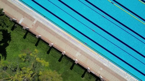 Aerial Top Down View of Outdoor Swimming Pool with Blue Water and Lane Lines 库存影片 333745135