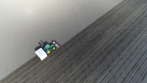 Aerial top down view over empty land showing tractor and farmer team 4k Stock Footage 78646875