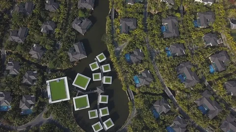Aerial Top Down view of overwater bungalows on the river surrounded with green Stock-Footage 128029875