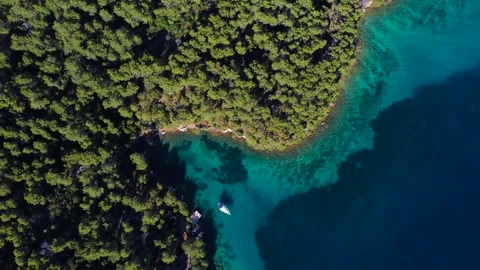Aerial top down view of paklina cove and a sailboat in hvar, croatia Video stock 340182152