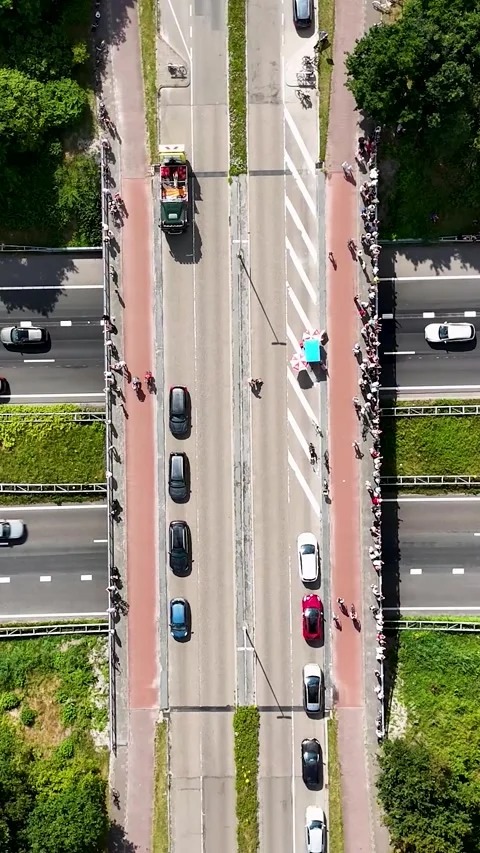 Aerial top down view of parade with float crossing a highway overpass Stock Footage 327109984