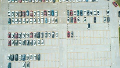 Aerial top down view a parking lot with cars of different colors. Camera moves Stock-Footage 165794103