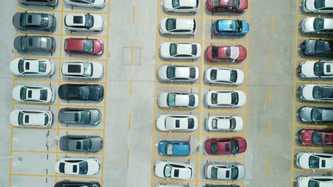 Aerial top down view a parking lot with cars of different colors. Camera moves Stock Footage 165794135