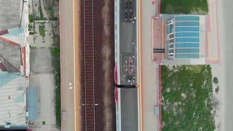 Aerial top down view of the passenger electric train leaving the station Stock Footage 142333379