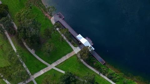 Aerial top-down view of people on a pier in a park Stock Footage 339377652