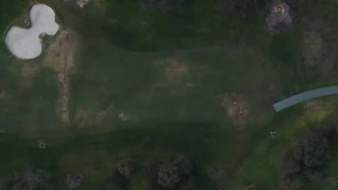 Aerial top-down view of people playing on a golf course Video stock 342580552
