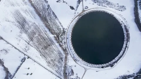 Aerial top down view of perfect oval lake surrounded by snow The Concept of.. Stock-Footage 327710112