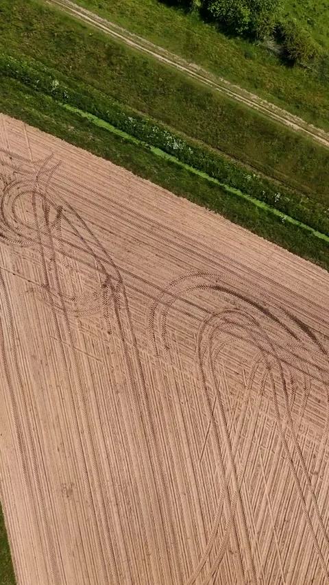 Aerial top-down view of a plowed field and roundabout 스톡 동영상 336496734
