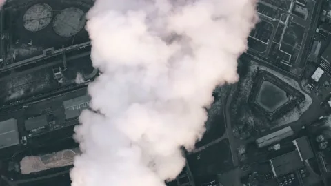 Aerial top-down view of a polluting smoke from a stack in depsessing obsolete Stock Footage 145399182