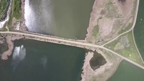 Aerial top-down view of a pond cascade and dam embankment Stock Footage 337884348