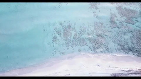 Aerial top-down view of a pristine tropical beach with white sand, turquoise Stock Footage 344389457