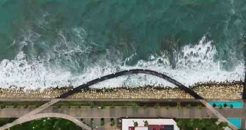 Aerial top down view of promenade, sea and pedestrian bridge. Stock Footage 259879894