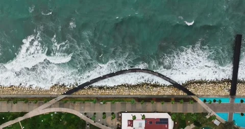 Aerial top down view of promenade, sea and pedestrian bridge. Stock Footage 314968418