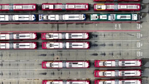 Aerial top down view of public transport buses parked at the parking depot .. Stock Footage 329663301