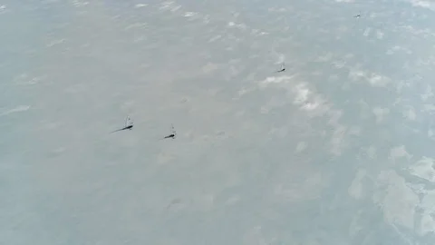 Aerial top-down view of racing ice boats approaching the downwind (leeward) mark Stock Footage 88201212