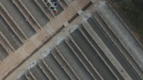 Aerial top-down view of raw brick rows with workers Stock Footage 346466326