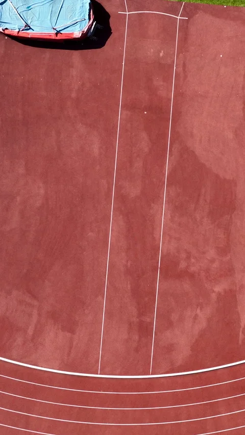 Aerial Top Down View Of Red Running Track With White Lane Markings Video stock 347967152