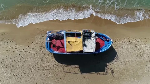 Aerial top down view of refugee boat showing the colourful painted hull 4k Stock Footage 237361185