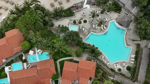 Aerial top down view of resort swimming pool with palm trees, summer vacatio Stock Footage 327653197